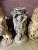 A composite stone and metalwork sun dial in the form of three muses