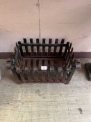 A distressed black painted cast metal fire basket