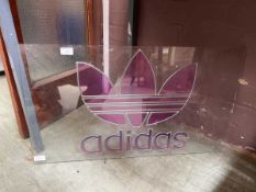 A stylized plate glass sign for ADIDAS