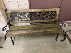 A weathered cast metal and wooden bench