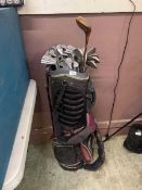 A golf bag containing assorted clubs by various makers to include Ram, Wilson, John Letters, etc
