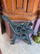 A pair of green painted bench ends
