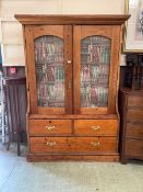 A late Victorian waxed pine full height bookcase with glazed doors and two short over one long