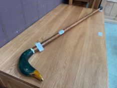 A walking cane with a duck's head handle