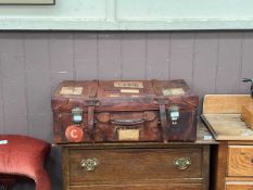 A vintage Grindlay & Co leather suitcase with Cunard and other labels
