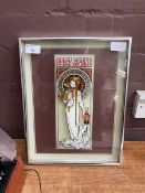 A framed Alphonse Mucha print on glass of an art nouveau lady
