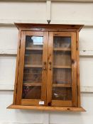 A waxed pine wall mounted display cabinet
