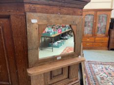 A rustic stripped pine wall mirror with trinket shelf