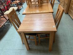 A modern oak square top kitchen table along with a pair of modern oak dining chairs - all by Oak