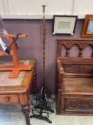 Two pieces of wrought iron work, a standard lamp base and a wine rack