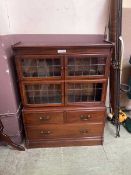 A Minty four section mahogany cupboard bookcase over drawers
