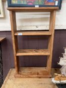 A small stripped pine open bookcase
