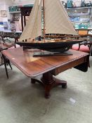 Late Victorian mahogany Pembroke table with single drawer on octagonal column, ending in 4 bun