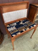 A modern teak canteen table containing silver plated Davenport and Sullivan cutlery