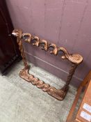 A modern stained wood stick/umbrella stand with twist design