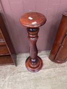A modern stained wood jardiniere stand with twist column