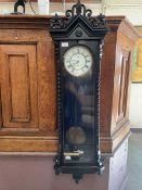 An ebonized cased drop-dial wall clock