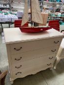 A modern white painted chest of four drawers