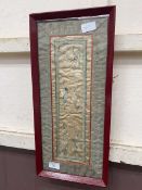 A framed and glazed oriental silk artwork depicting flowers