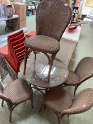 A Lloyd Loom bistro table along with four matching chairs