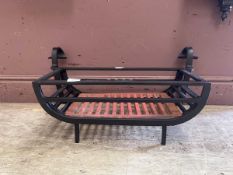 A modern cast metal black fire grate