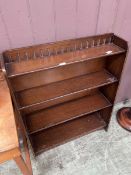 A stained wood four tier waterfall bookcase