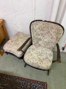A dark Ercol stick back armchair with matching footstool (sold subject to our company soft