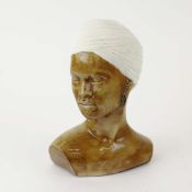 A CERAMIC NUBIAN BUST OF A LADY.