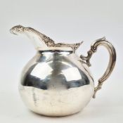 A PERUVIAN STERLING SILVER WATER JUG.