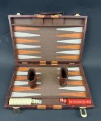 A LEATHERETTE CASED BACKGAMMON SET.