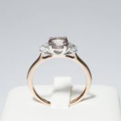 A 9CT ROSE GOLD TRILOGY RING.