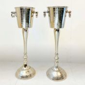 PAIR OF POLISHED METAL WINE COOLERS ON STANDS.