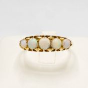 AN EARLY 20TH CENTURY YELLOW METAL (TESTS 18CT GOLD) OPAL RING.