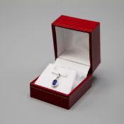 AN 18CT WHITE GOLD SAPPHIRE AND DIAMOND CLUSTER PENDANT.