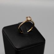 A 9CT GOLD DIAMOND SOLITAIRE RING.