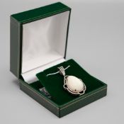 AN OPAL AND DIAMOND PENDANT NECKLACE.