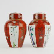 A PAIR OF HEREND PORCELAIN LIDDED RED DYNASTY VASES. (2).