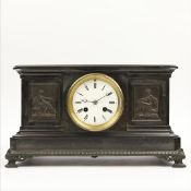 A 19TH CENTURY BLACK SLATE MANTLE CLOCK.