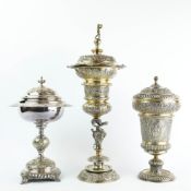 A GERMAN SILVER GILT STANDING CUP AND COVER AND TWO OTHERS. (3).