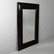 ANDREW MARTIN WALL MIRROR WITH A BLACK PAINTED FRAME.