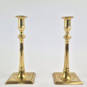 A PAIR OF GEORGE III BRASS CANDLESTICKS.