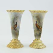A ROYAL WORCESTER PAIR OF SMALL VASES.