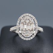 A LARGE OVAL DIAMOND CLUSTER RING.