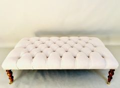 HEARTH STOOL WITH NEUTRAL LINEN DEEP BUTTONED UPHOLSTERY ON TURNED SUPPORTS.
