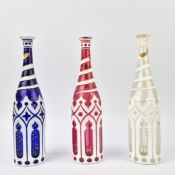 SET OF THREE BOHEMIAN GLASS DECANTERS.