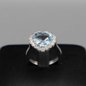 AN 18CT WHITE GOLD AQUAMARINE AND DIAMOND CLUSTER RING.