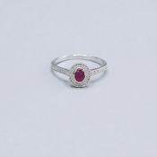 A 9CT WHITE GOLD RUBY AND DIAMOND DRESS RING.