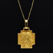AN 18CT GOLD RELIGIOUS PENDANT NECKLACE.