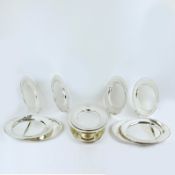 GUY DEGRENNE, A COLLECTION OF TWELVE SILVER PLATED PLATTERS.