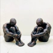 PAIR OF SITTING MAN SCULPTURES IN BRONZED FINISH RESIN.